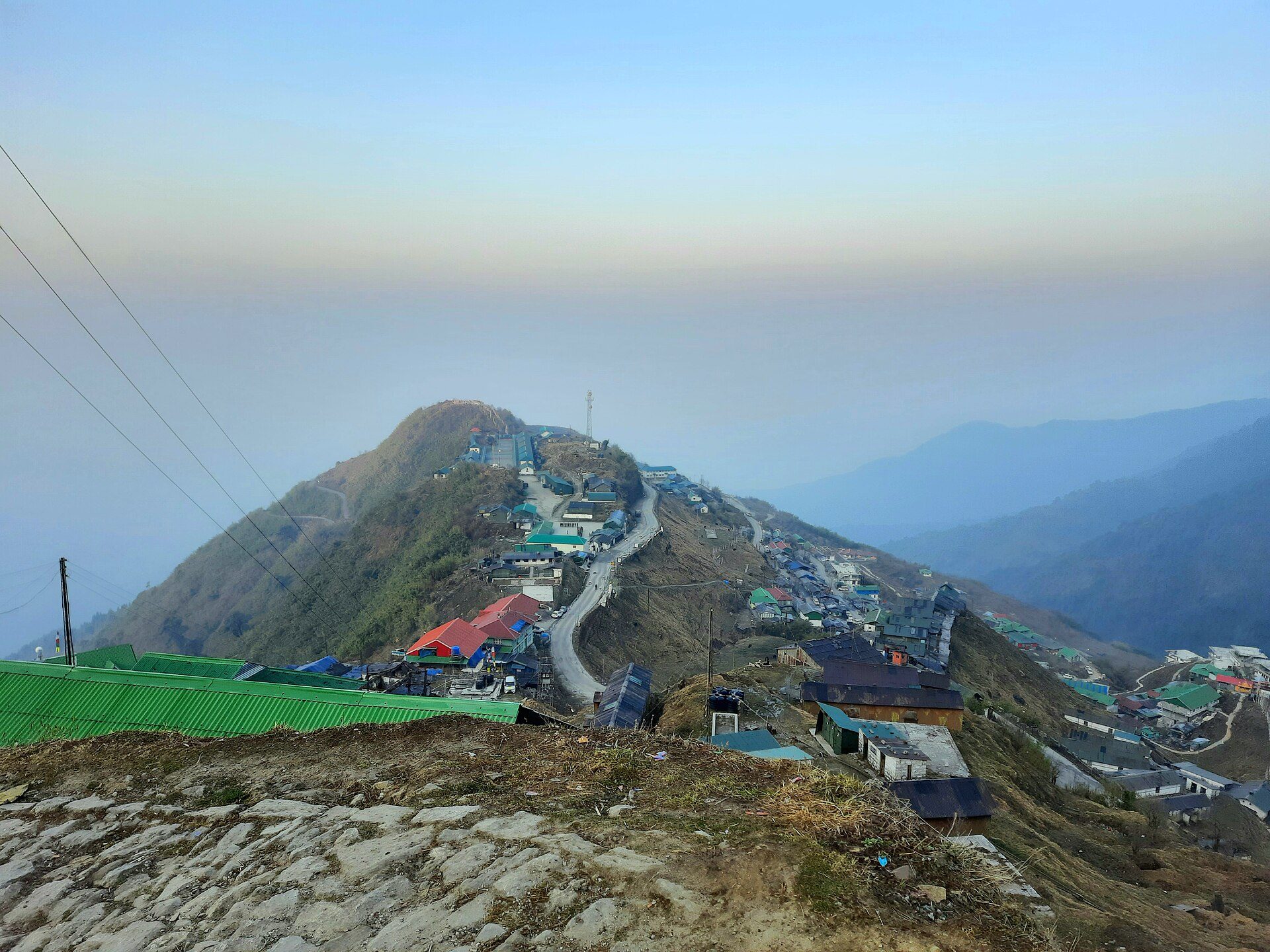 High-altitude ridge settlement and winding mountain road at Zuluk at dawn along the historic Old Silk Route in East Sikkim